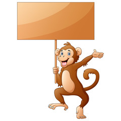Monkey cartoon holding a wooden sign on white background © dreamblack46