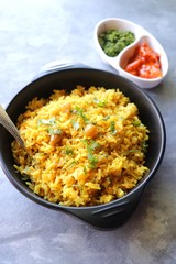 Indian comfort Food - Fresh Masala peanuts rice also known as Peanuts Pulav or rice khichdi. Garnished with coriander. Served hot with green chutney and mango pickle. with Copy space. 