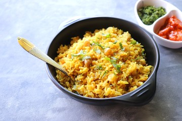 Indian comfort Food - Fresh Masala peanuts rice also known as Peanuts Pulav or rice khichdi. Garnished with coriander. Served hot with green chutney and mango pickle. with Copy space. 