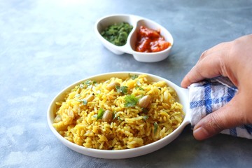 Indian comfort Food - Fresh Masala peanuts rice also known as Peanuts Pulav or rice khichdi. Garnished with coriander. Served hot with green chutney and mango pickle. with Copy space. 