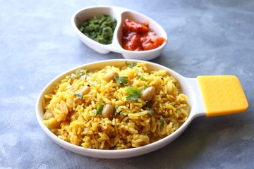 Indian comfort Food - Fresh Masala peanuts rice also known as Peanuts Pulav or rice khichdi. Garnished with coriander. Served hot with green chutney and mango pickle. with Copy space. 