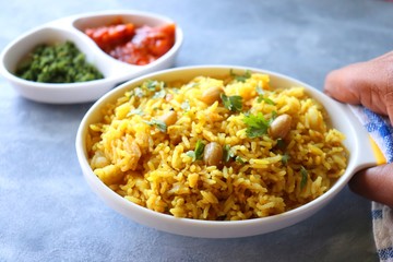Indian comfort Food - Fresh Masala peanuts rice also known as Peanuts Pulav or rice khichdi. Garnished with coriander. Served hot with green chutney and mango pickle. with Copy space. 