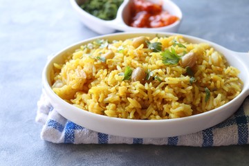 Indian comfort Food - Fresh Masala peanuts rice also known as Peanuts Pulav or rice khichdi. Garnished with coriander. Served hot with green chutney and mango pickle. with Copy space. 