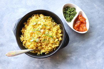 Indian comfort Food - Fresh Masala peanuts rice also known as Peanuts Pulav or rice khichdi. Garnished with coriander. Served hot with green chutney and mango pickle. with Copy space. 
