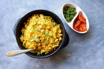 Indian comfort Food - Fresh Masala peanuts rice also known as Peanuts Pulav or rice khichdi. Garnished with coriander. Served hot with green chutney and mango pickle. with Copy space. 