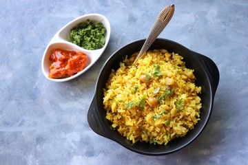 Indian comfort Food - Fresh Masala peanuts rice also known as Peanuts Pulav or rice khichdi. Garnished with coriander. Served hot with green chutney and mango pickle. with Copy space. 