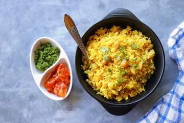 Indian comfort Food - Fresh Masala peanuts rice also known as Peanuts Pulav or rice khichdi. Garnished with coriander. Served hot with green chutney and mango pickle. with Copy space. 
