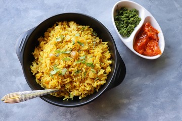 Indian comfort Food - Fresh Masala peanuts rice also known as Peanuts Pulav or rice khichdi. Garnished with coriander. Served hot with green chutney and mango pickle. with Copy space. 