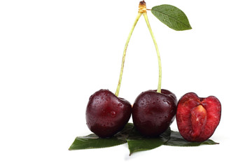 Two cherries with a half and leaves