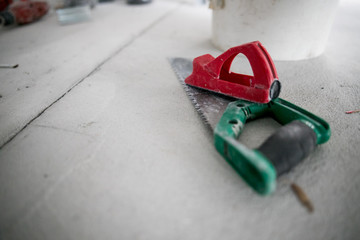 Workplace and tools of a carpenter or builder.Handsaw lies on the working surface