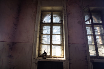Fototapeta na wymiar Spooky window with lantern and spider web.