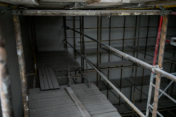 Scaffolding and wall plastering in buildings are under construction
