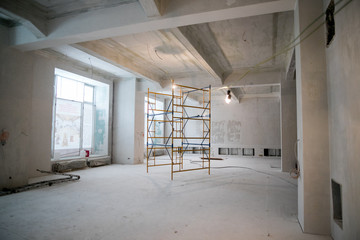 Interior construction of warehouse concrete wall and scaffolding.