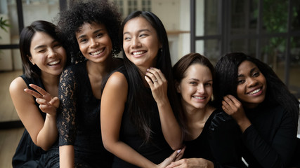 Portrait happy Asian bride showing engagement ring with bridesmaids