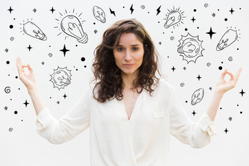 Calm young woman showing meditation sign. Tranquil curly lady looking at camera. Meditating concept