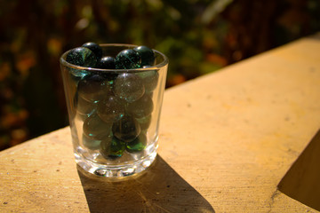 	1. Single glass green marble ball with a nice shadow and impressive light with blur background