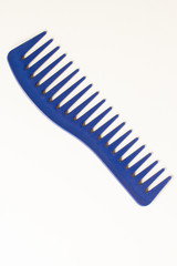 blue comb hairdressing tool on white background.