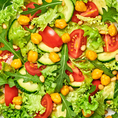 Vegan greens salad, chickpeas, lettuce, arugula, cherry tomatoes. Home made vegetarian green salad. Diet, vitamin food concept. Tasty veg mix leaves salad background, closeup, macro