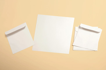 White envelope and post card on background. Top view blank envelope mockup and blank letterhead...