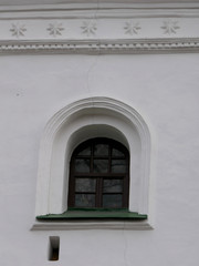 Semicircular retro windows in a white brick wall of an old church. Historic Site, Cultural Heritage, and Architectural Monument
