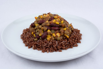 A Vegan Meal With Red Rice, Green Lentisl, Corn and Beans