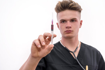 Doctor with syringe. Young doctor in medic uniform holding syringe in hand with glove isolated on white