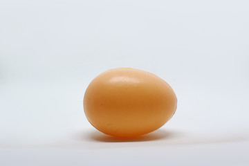 photo of a toy chicken egg made of plastic with a separate white background