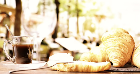 Fresh pastries on the table. French flavored croissant and coffee.