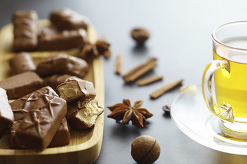 Chocolate bars on a black background in backlight. Chocolate with filling. Sweet sweets for snack and tea.