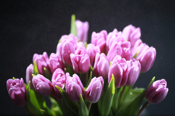 Obraz premium Bouquet of fresh flowers. Holiday gift to your loved one. Background St. Valentine's Day. Rose, tulip, iris flower arrangement.