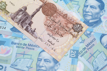 A close up image of an Egyptian one pound bank note with Mexican twenty peso bank notes in macro