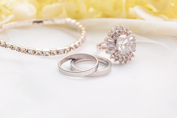 Beautiful wedding and engagement rings on white background