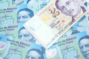 Fototapeta premium A close up image of a two dollar bill from Singapore close up in macro with Mexican twenty peso bank notes