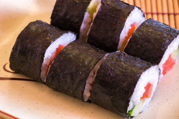 Eating at home. Asian food. Japanese food. Sushi and rolls. Rolls with rice and red fish. Cook and eat at home. Home made sushi party at home. Food concept.