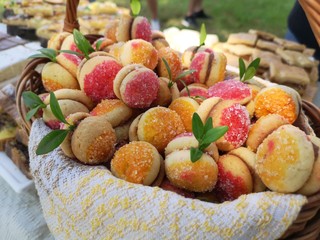 Cakes that are shaped like apricots. A beautiful presentation of the products at a fair with sweets