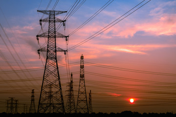 Fototapeta premium High voltage power tower and beautiful nature landscape at sunset