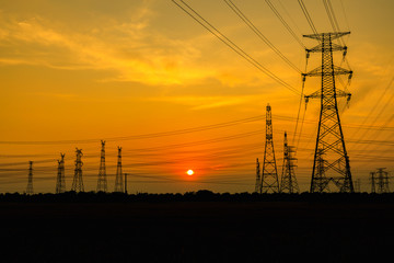 Fototapeta na wymiar High voltage power tower and beautiful nature landscape at sunset