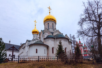 An ancient white-stone Orthodox church with golden domes on the territory of the Savvino-Storozhevsky monastery in the city of Zvenigorod (Russia)