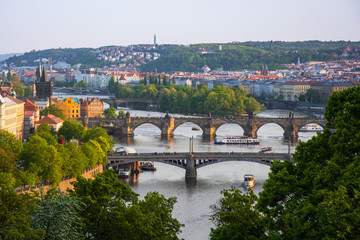Fototapeta na wymiar View from Letna to Prague city and Charles Bridge that crosses Vltava river, Prague.
