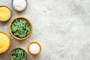 Mineral bath salt on grey background top-down frame copy space