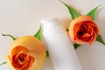 Cosmetic bottles with rose petals, copy space