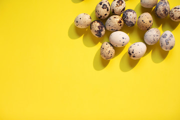 Flat lay.  Bright yellow easter background with eggs. Text spase