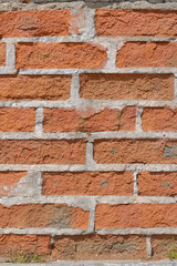 Background of collapsing brick wall, texture of the old cracked red brickwork