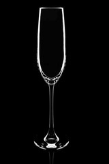 Empty champagne glass on a black background, elegantly illuminated on the sides. Concept, mysterious club life. Magazine and commercial photo with place for text or design, festival and holiday food
