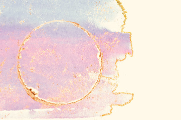 Shiny golden round frame on blue and pink watercolor stains on white background