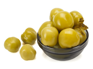 Pickled green tomatoes in a plate on a white background