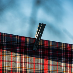 cloth napkins are dried on a clothesline outdoors in the morning.