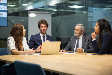 Thoughtful business team brainstorming in conference room. Group of office employees sitting at table and discussing new strategy. Business, teamwork concept