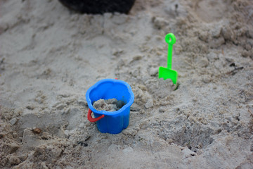 Blue bucket with the sand on playground