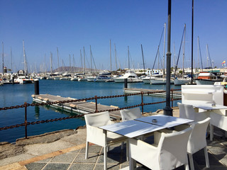 Fototapeta premium empty table of a restaurant with harbor view in Lanzarote, Playa Blanca